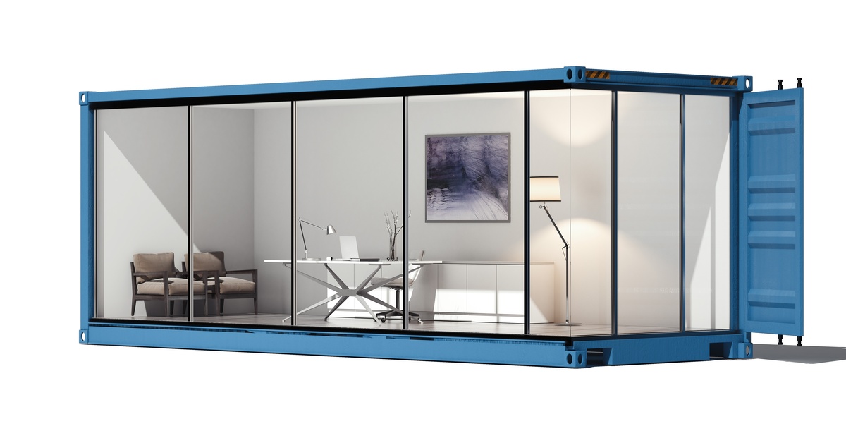 An illustration of a modular container with a set of chairs, a desk, laptop, lamp and painting inside of it.